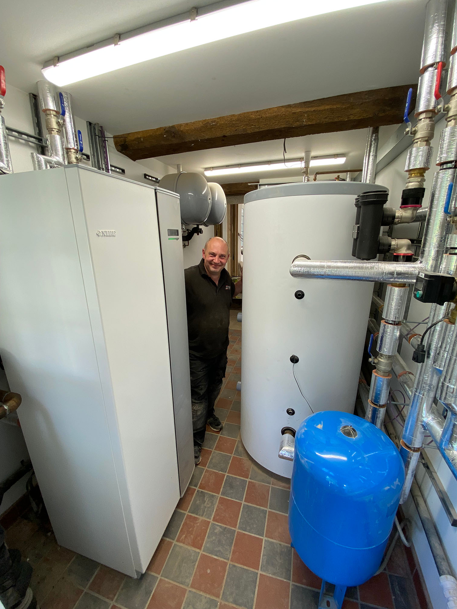 Will Blair standing next to his heat pump installation